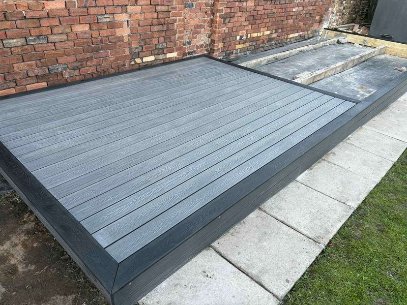 Grey composite decking with a charcoal border in Rhosllanerchrugog, Wrexham