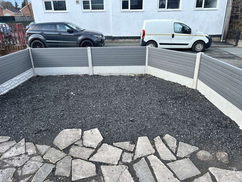 Grey composite fencing around a gravelled front garden in Pen-y-Cae, Wrexham