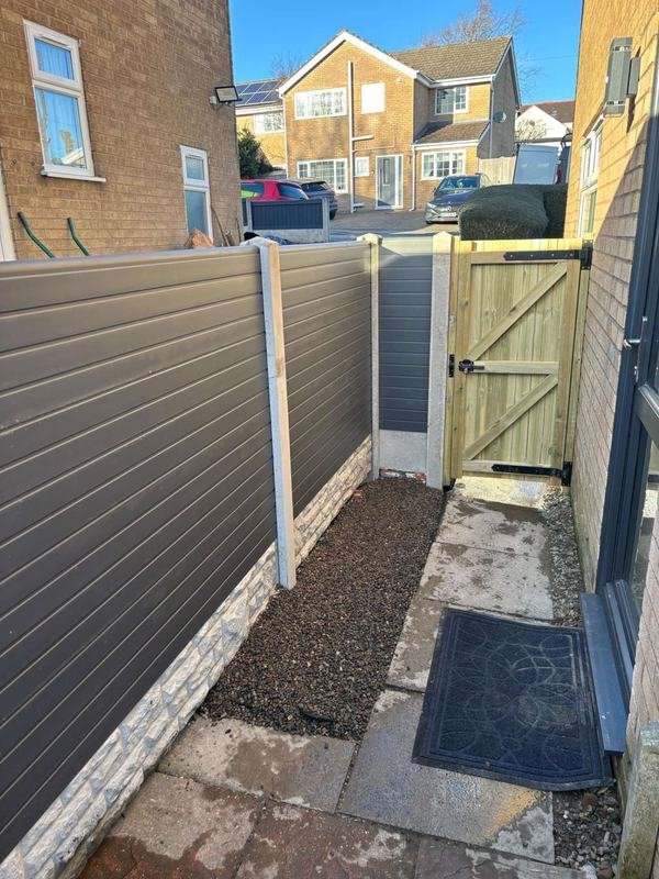 Fence extension and gate closing off a side passage in Coedpoeth, Wrexham