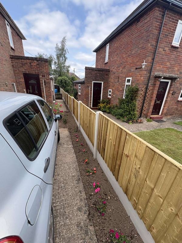 Feather edge fence panels running alongside a driveway in Ellesmere, Shropshire