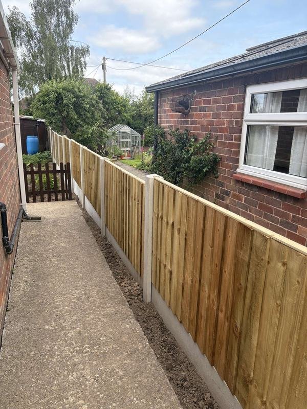 New feather edge fence on concrete posts beside a garden path in Ellesmere, Shropshire