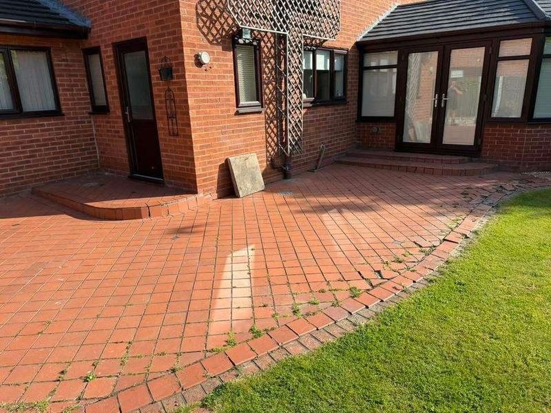 Curved cobble border edging a sandstone patio in Cross Lanes, Wrexham