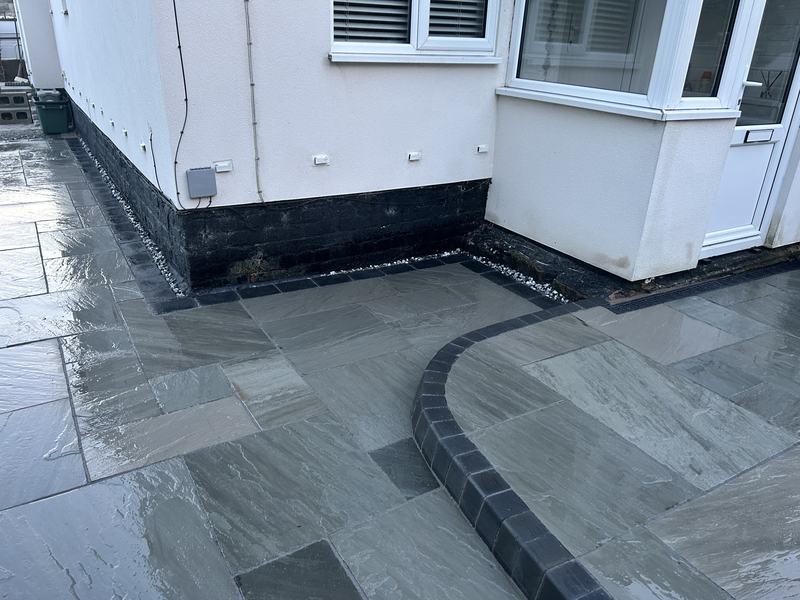Kandla grey Indian stone patio with a charcoal sett border in Bersham, Wrexham