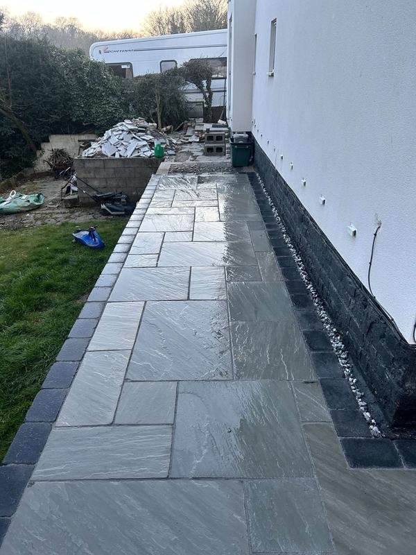 Kandla grey stone path running down the side of a house in Bersham, Wrexham