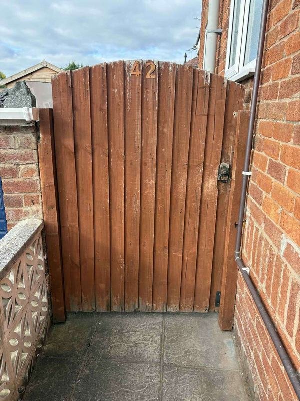 Custom arched timber gate fitted against brickwork in Acrefair, Wrexham