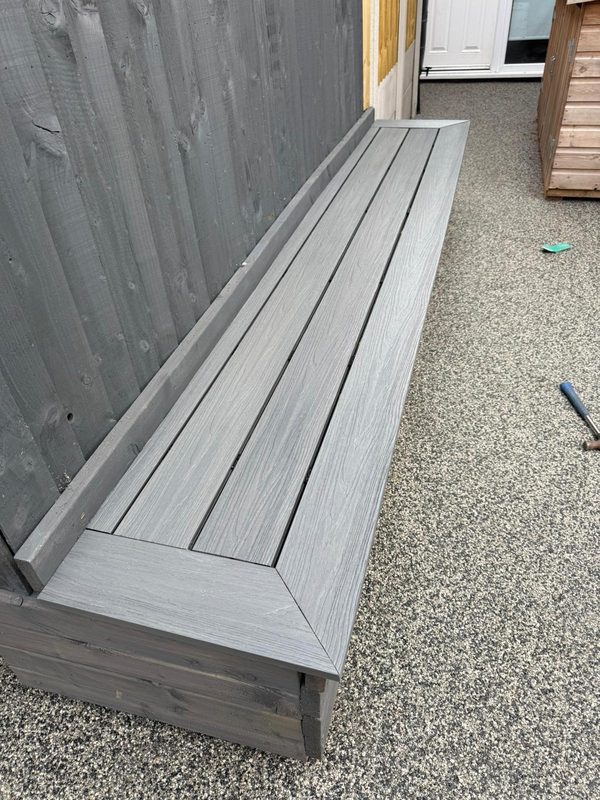 Mitred picture-frame edge on a composite-topped garden bench in Rhosllanerchrugog