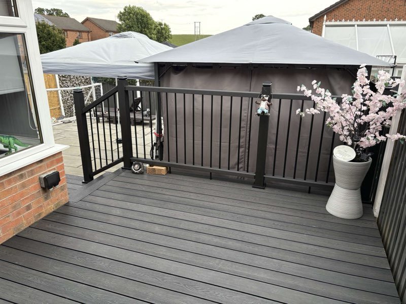 Charcoal composite decking with a matching balustrade and gazebo in Abenbury, Wrexham