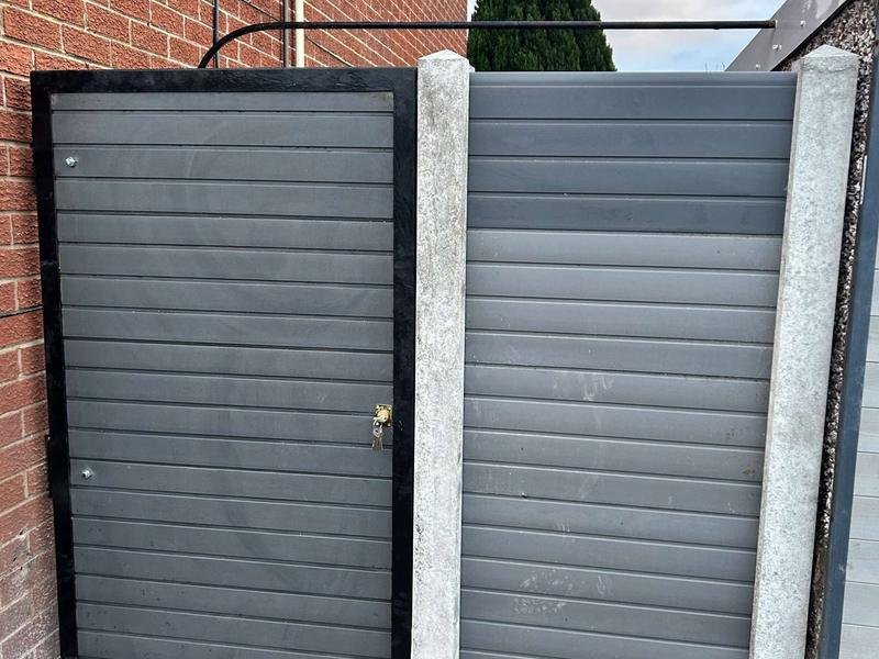 Grey composite fence panels and a steel-framed bespoke gate in Pen-y-Cae, Wrexham