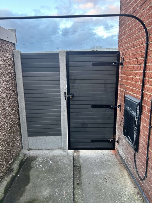 Grey composite fence panels and a steel-framed bespoke gate in Pen-y-Cae, Wrexham