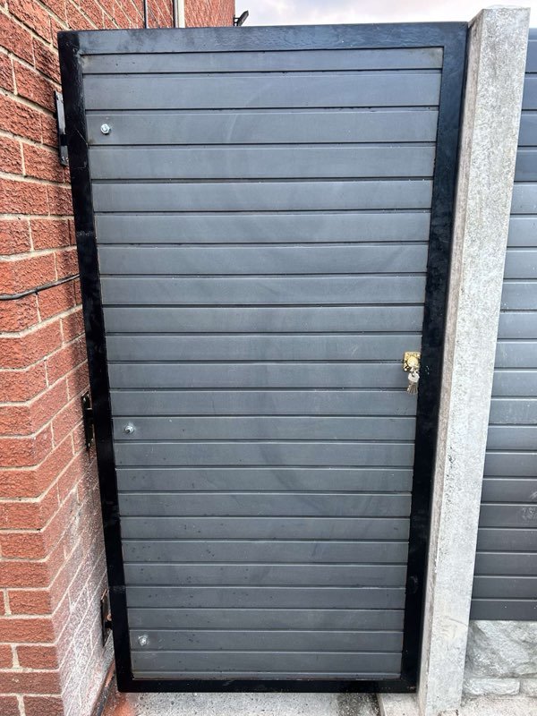 Grey composite fence panels and a steel-framed bespoke gate in Pen-y-Cae, Wrexham
