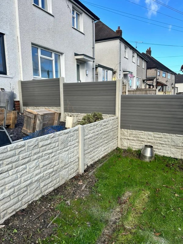 Grey composite fencing above a concrete retaining wall in Gwynfryn, Wrexham