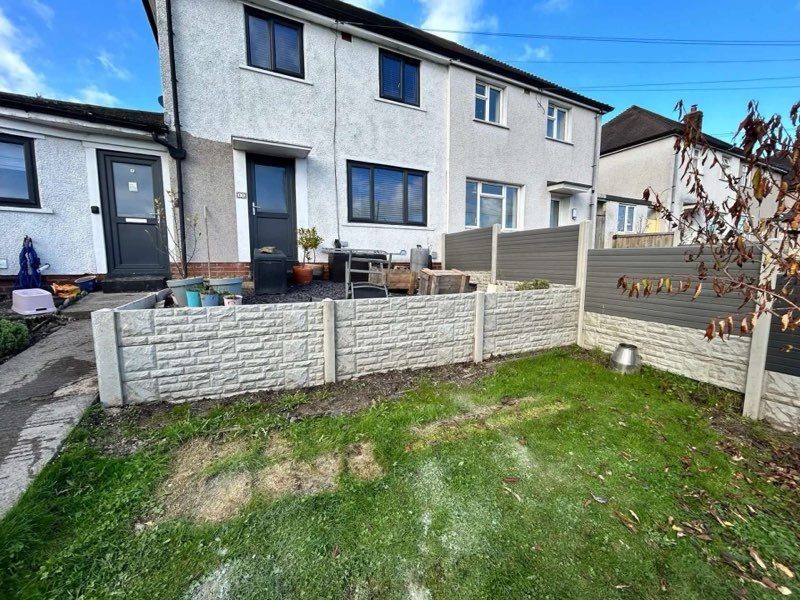 Grey composite fencing above a concrete retaining wall in Gwynfryn, Wrexham