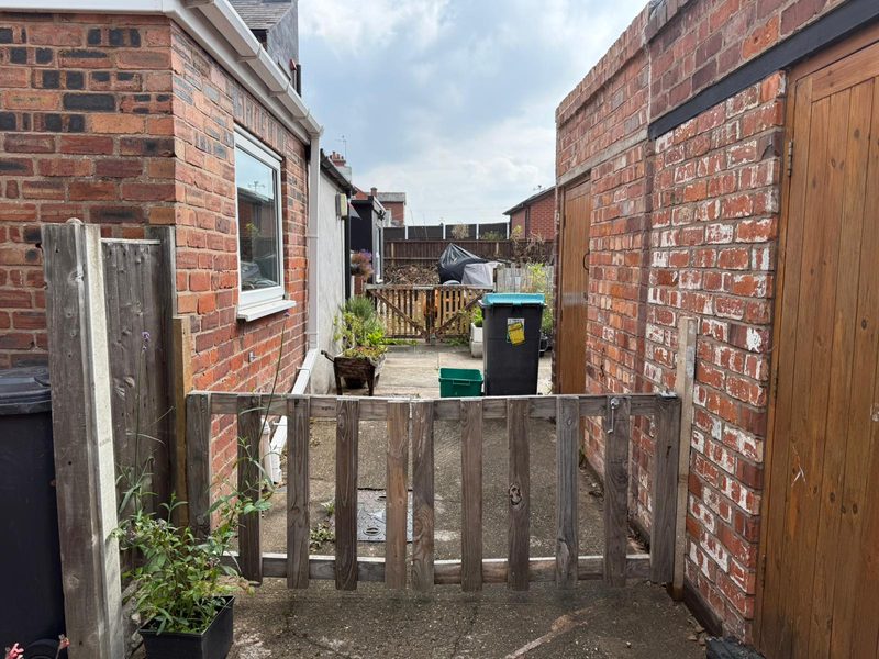 The low, weathered picket gate in Marchwiel before it was replaced