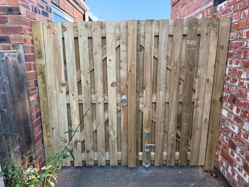 Full-height braced timber gate built to measure between two brick walls in Marchwiel, Wrexham