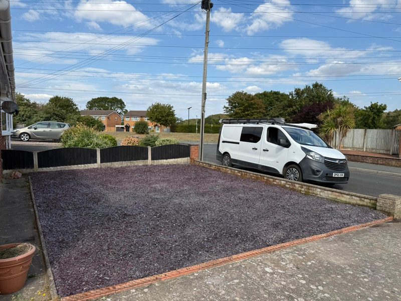Front garden laid with plum decorative slate and edged in brick in Johnstown, Wrexham