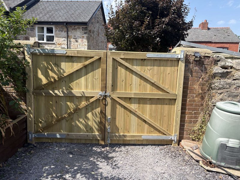 Picket fencing on concrete posts across the front of a cottage in Caegwrle, Wrexham