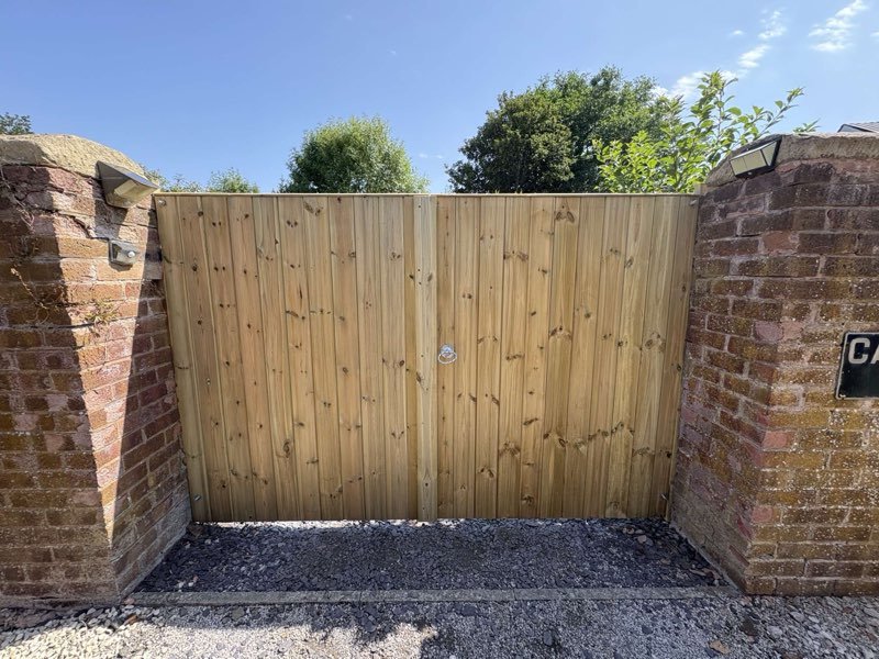 Picket fencing on concrete posts across the front of a cottage in Caegwrle, Wrexham