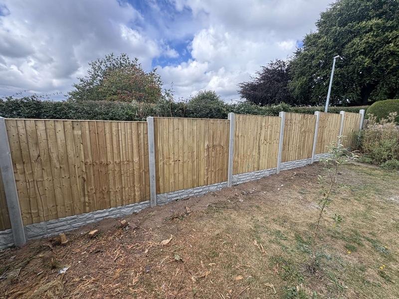 New feather edge rear fence with concrete posts and gravel boards in Bryn Offa, Wrexham