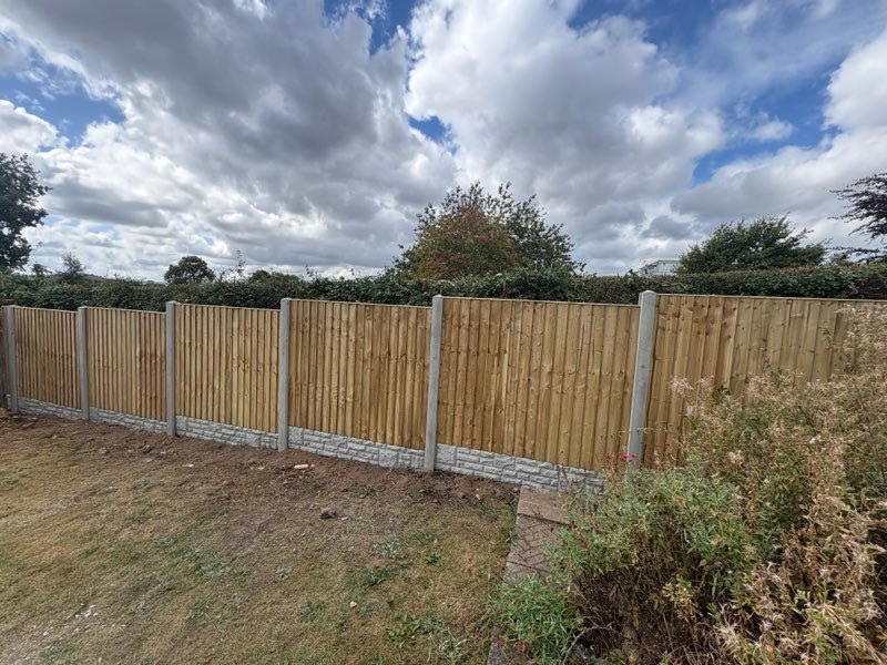 New feather edge rear fence with concrete posts and gravel boards in Bryn Offa, Wrexham