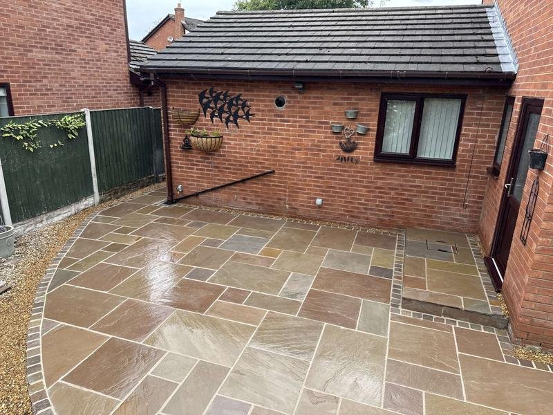 Raj blend Indian sandstone patio with a cobble border in Cross Lanes, Wrexham