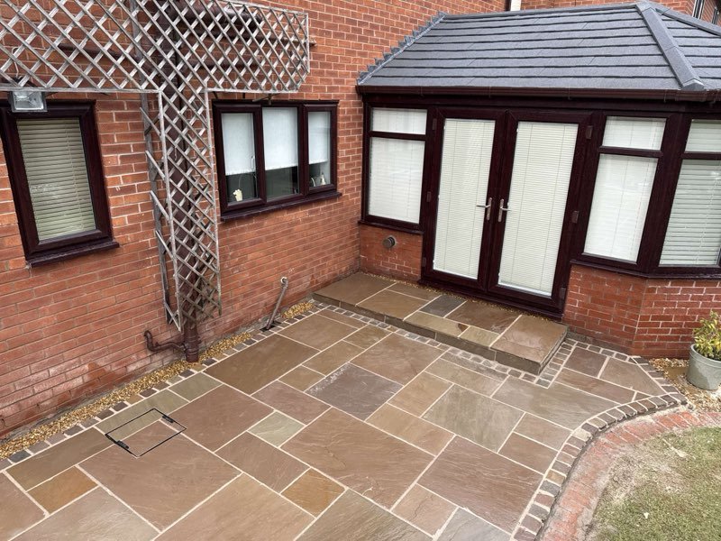 Raj blend Indian sandstone patio with a cobble border in Cross Lanes, Wrexham