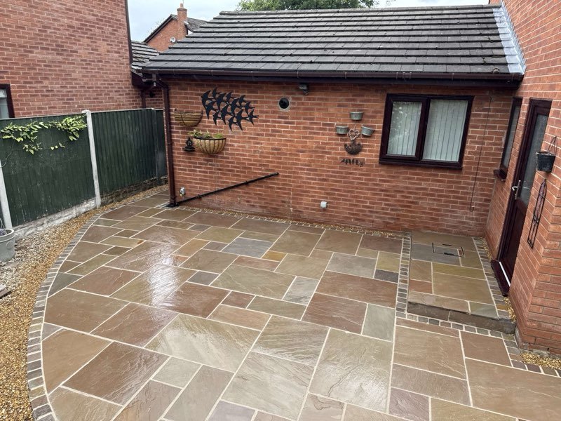Raj blend Indian sandstone patio with a cobble border in Cross Lanes, Wrexham