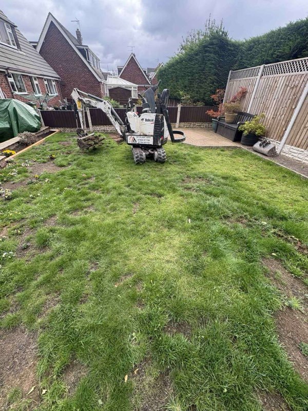Freshly laid striped turf lawn after a full drainage fix in Marchwiel, Wrexham