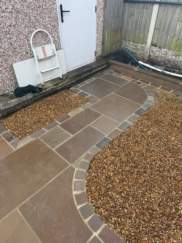 Curved Raj cobble path through Raj Green Indian stone with golden gravel either side in Gwersyllt, Wrexham