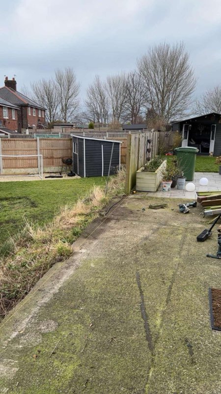 New timber fence replacing a storm-damaged run on a sloping garden in Brymbo, Wrexham