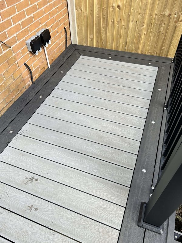 Grey composite decking with aluminium balustrades replacing an old timber deck in Tan-y-Fron, Wrexham