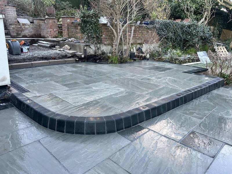 Kandla grey Indian stone patio with charcoal setts and KL kerbs in Bersham, Wrexham