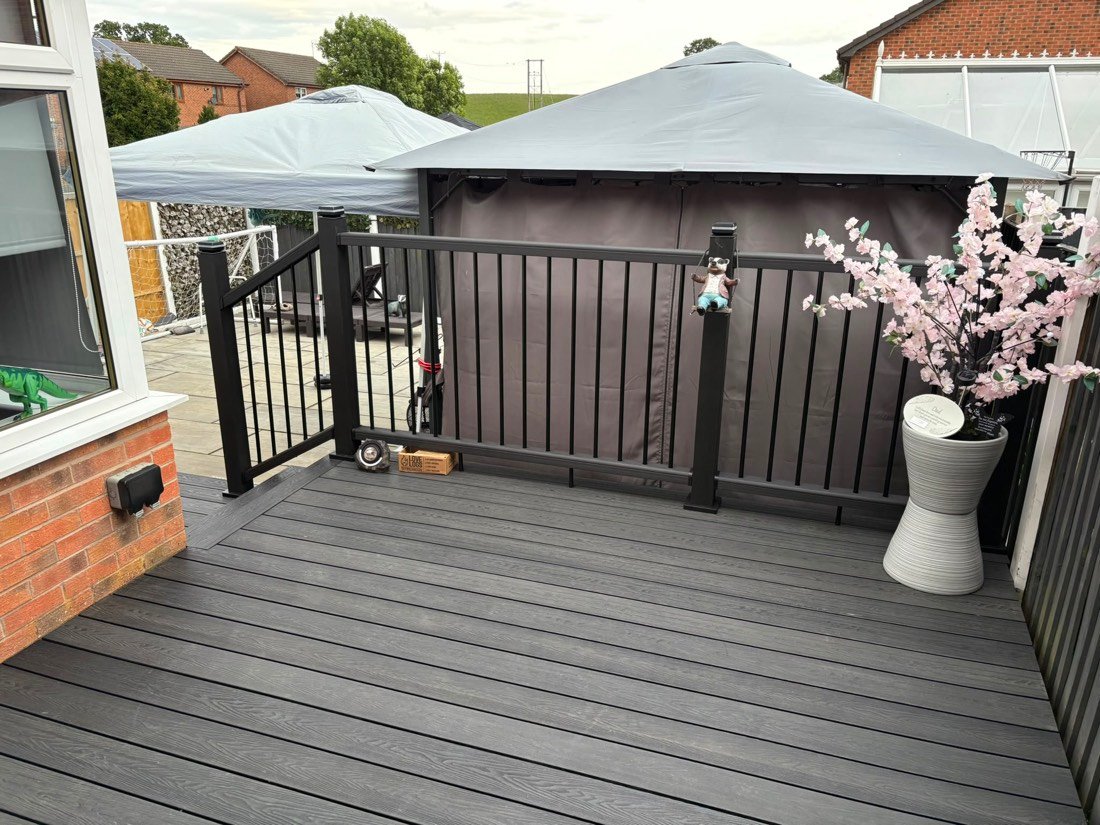 Grey composite deck with a black metal balustrade and gazebo, Wrexham